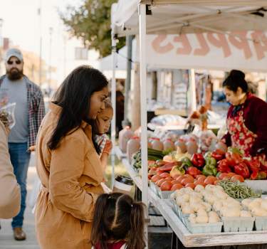 Family browsing produce at the Effingham Farmers Market