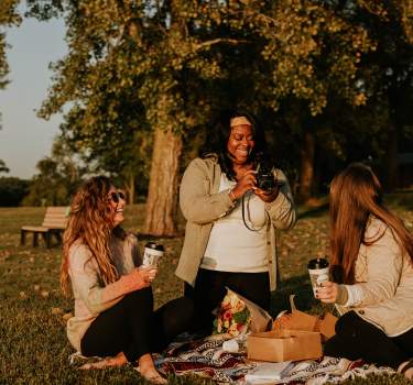 Girls having a picnic photoshoot for Joe Sippers Cafe at Lake Sara