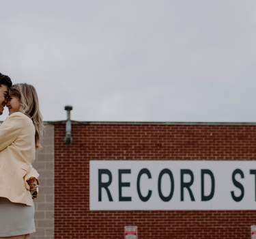 Couple standing in front of America's Groove Record Store