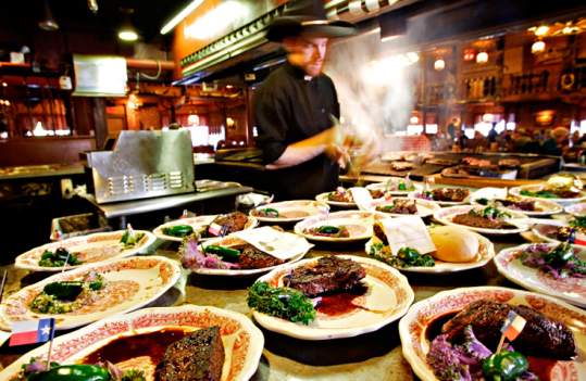many dishes of steaks plated ready to be served at the big texan steak ranch in amarillo, texas