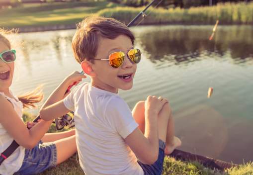 two kids fishing at a lake