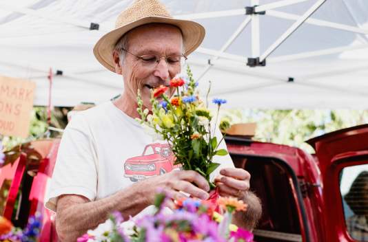 Boulder Farmers Market Man with flowers