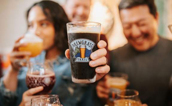 People enjoying beverages on the brewgrass trail