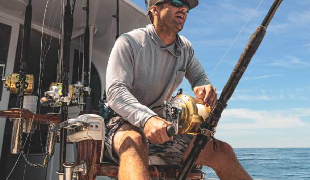 Man fishing off charter boat in the ocean