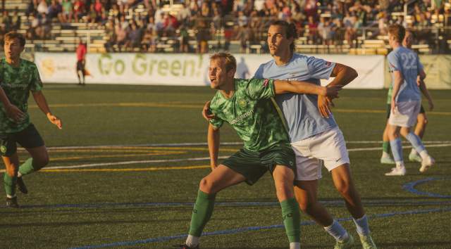 Vermont Green soccer player blocks opposing team