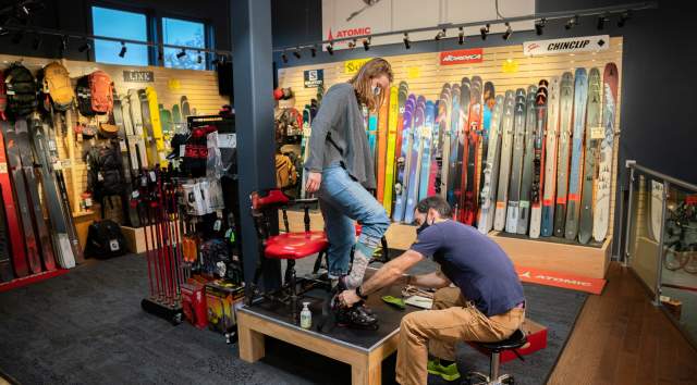 ski boot fitting with many skis behind