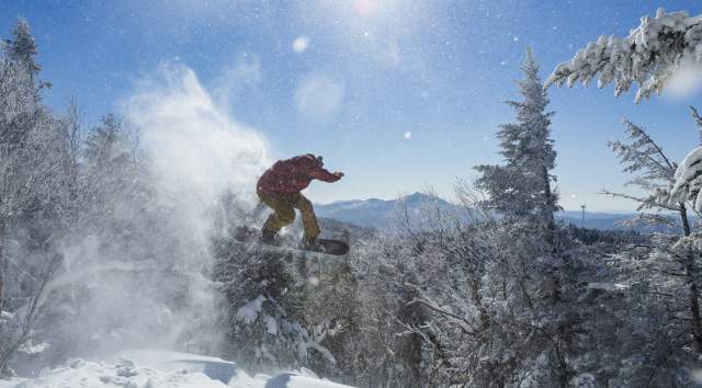 snowboarder shredding the gnar on a sunny winter day