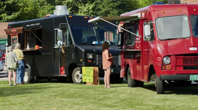 Food Trucks in a grass field serving delicious food made in Vermont