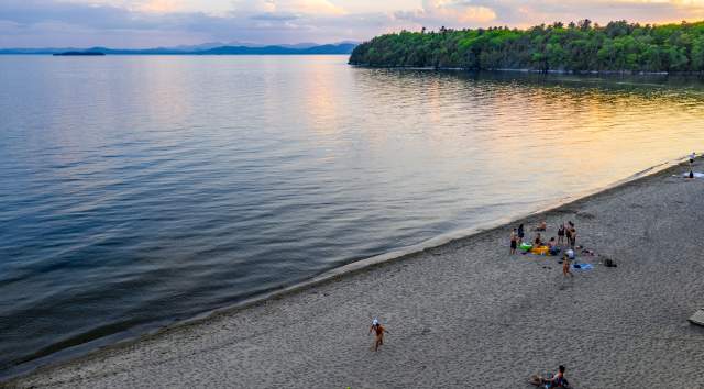 calm lake with beachgoers