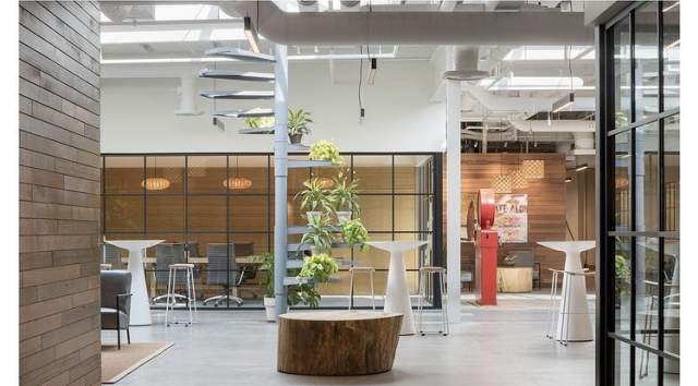 Indoor meeting venue at Hula Lakeside, featuring high ceilings, earthy decor, and an open concept seating area.