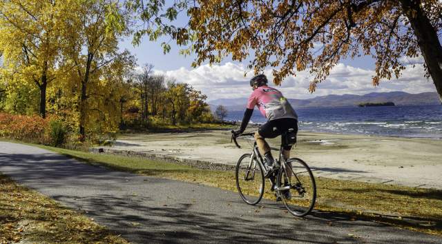 fall colors along Lake with bike rider