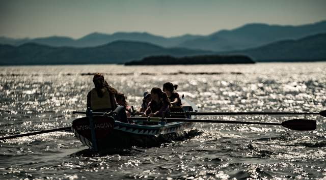 people rowing on lake champlain