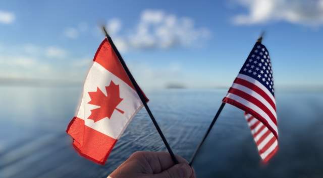 Canadian and United States Flags against Lake Champlain background