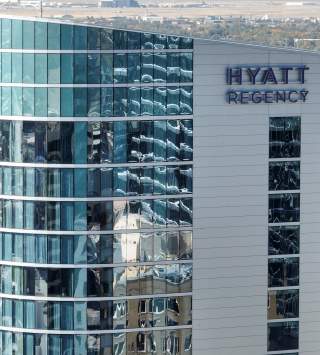 A picture showing the top floors of the Hyatt Regency focused on the sign