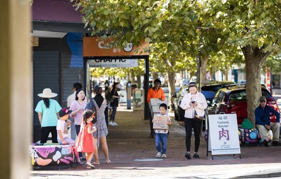 People walking down the street in Victoria Park in Perth City