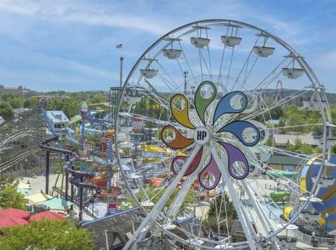Aerial view of an amusement park with a large Ferris wheel