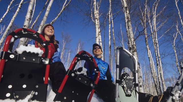 Snowshoers taking a break with snowshoes stuck in the snow