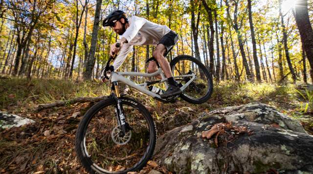 A racer rides his mountain bike over the rocky trails at Oak Mountain State Park.