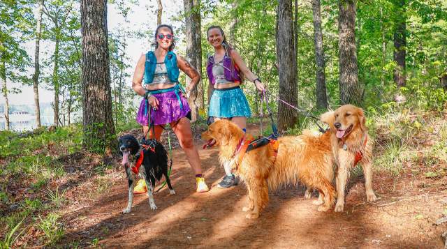 2 ladies hiking with dogs