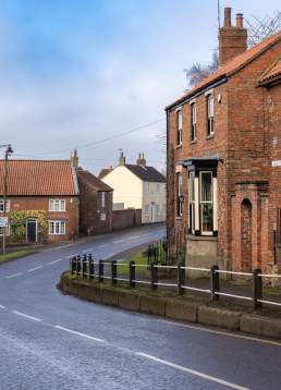 A quiet street in Caistor with houses and road going through the centre