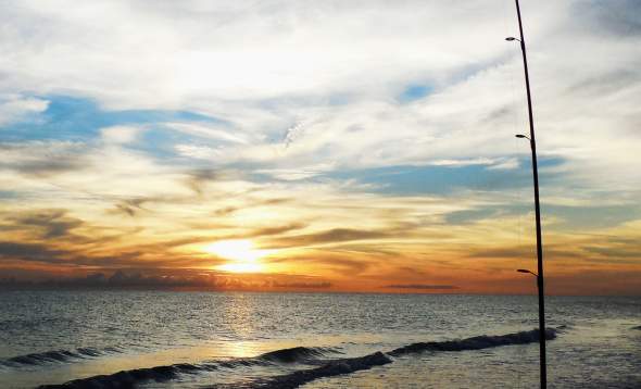 Fishing pole in the sand at sunrise on Boca Grande