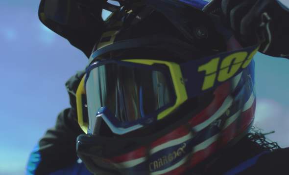 Close-up image of Amanda Carr putting on racing goggles