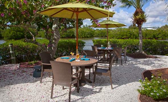 Umbrella tables near the water at Farlow's on the Water