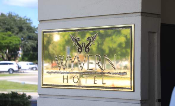 Greenery Reflected in The Wyvern Hotel's Name Plate