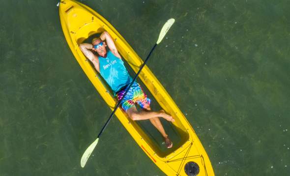 Aaron Koher of Glass Bottom Rentals laying in kayak - aerial view