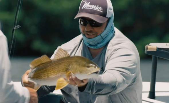 Capt. Jay Withers holding a redfish