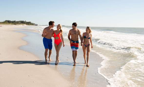 Two couples walking on beach at Don Pedro Island State Park