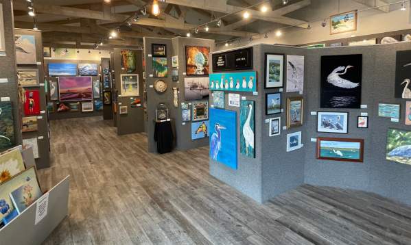Beach and wildlife themed paintings line the walls at the Port Aransas Art Center