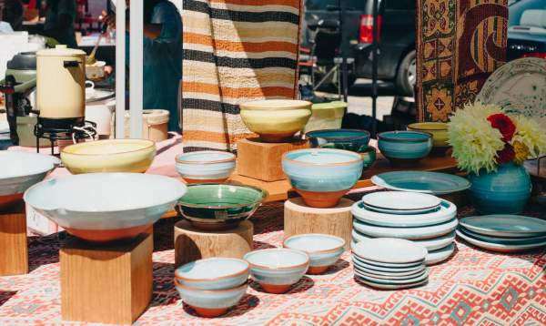 A table full of colourful bowls and plates.