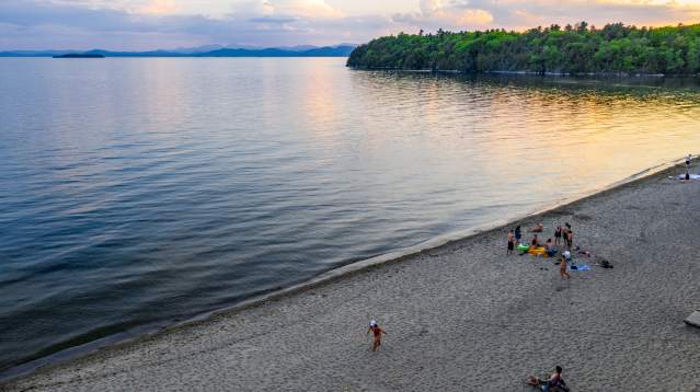 calm lake with beachgoers