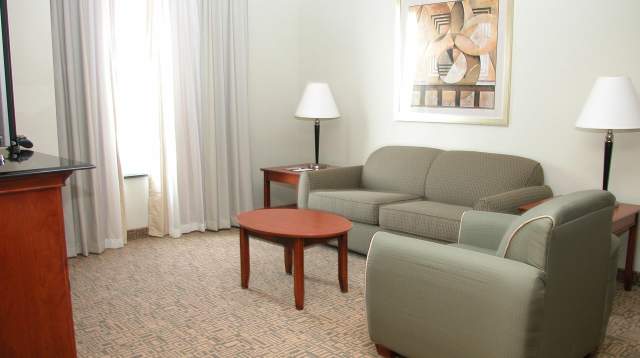 Quiet hotel sitting area with sofa and soft lighting that could be designated as a low-stimulus space during sports events