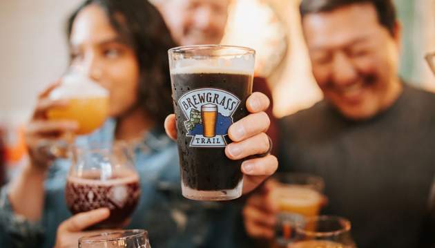 People enjoying beverages on the brewgrass trail