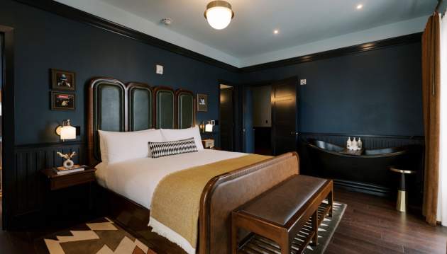 Hotel room with bed, rug, nightstand