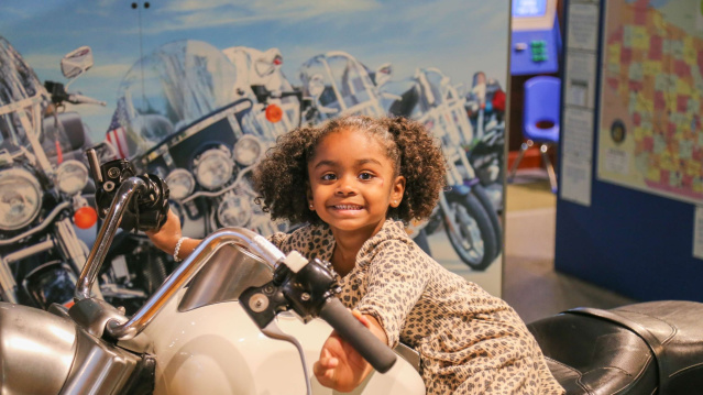 Girl smiling on a Harley-Davidson Motorcylce