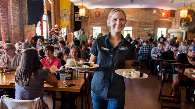 Server carrying plates at Lakefront Brewery