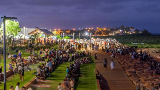 People gathered along the Staircase to the Moon viewing terrace at Town Beach Broome with the night markets in the background