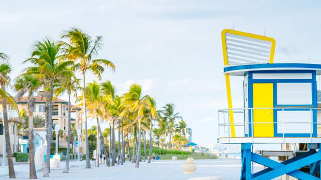 A brightly-colored lifeguard stand watches over the white sands of Hollywood Florida
