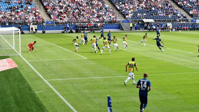 soccer players on the field with stadium audience in the background