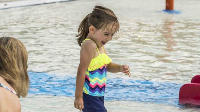 Child playing in the shallows at Franklin Family Aquatic Center.