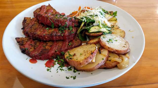 A plate of dutch-oven potatoes, steamed vegetables, and meatloaf from local restaurant Bowman's Cowboy Kitchen in Cedar City, Utah.