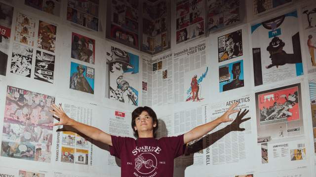 man in front of a wall of art