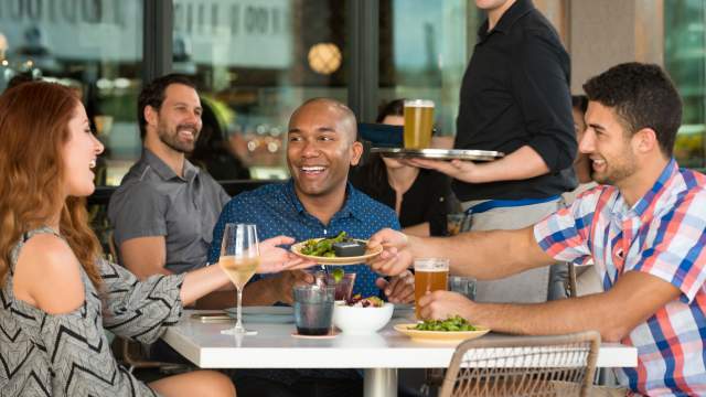 Chroma Modern Bar + Kitchen guests sharing appetizers and drinks