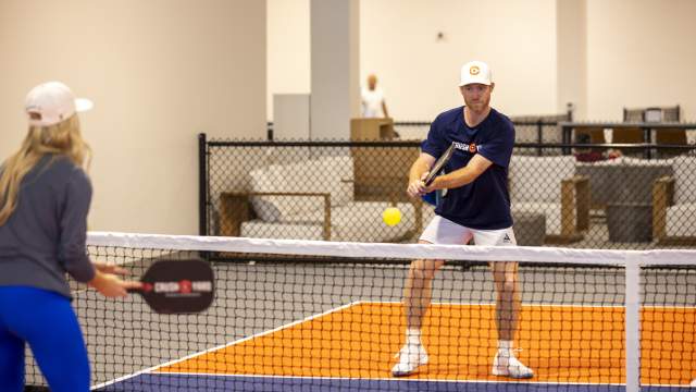 Anna Cooke, director of marketing, faces off against Evan Addington, director of pickleball, at Crush Yard Orlando, a 48,000-square-foot facility that recently opened in Kissimmee on Jan. 14, 2025. (Patrick Connolly/Orlando Sentinel)