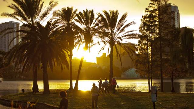 people gathered along Lake Eola at sunset
