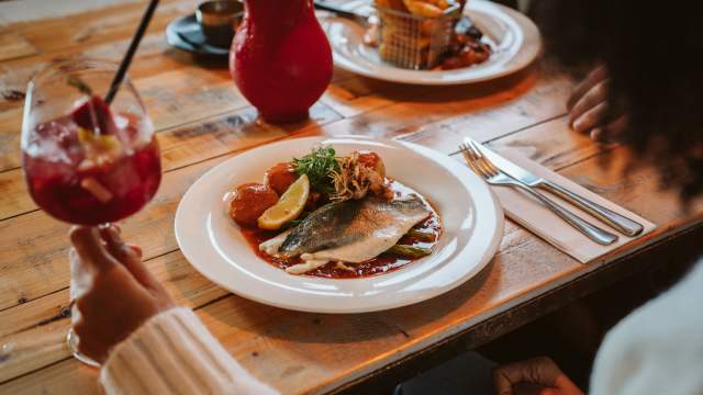 A lady enjoying a meal at El Pescador