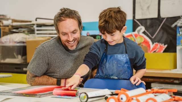 A man and child doing arts and crafts